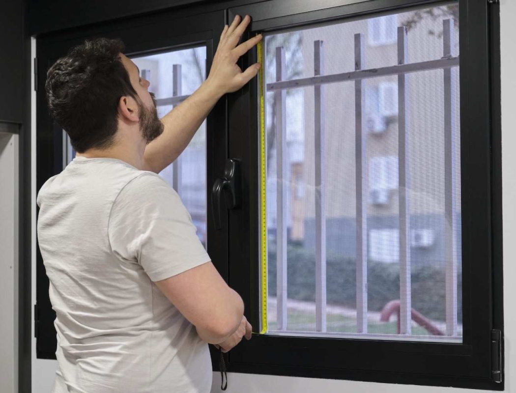man-measures-a-window-with-a-measuring-tape-2026-03-24-12-54-09-utc (1)
